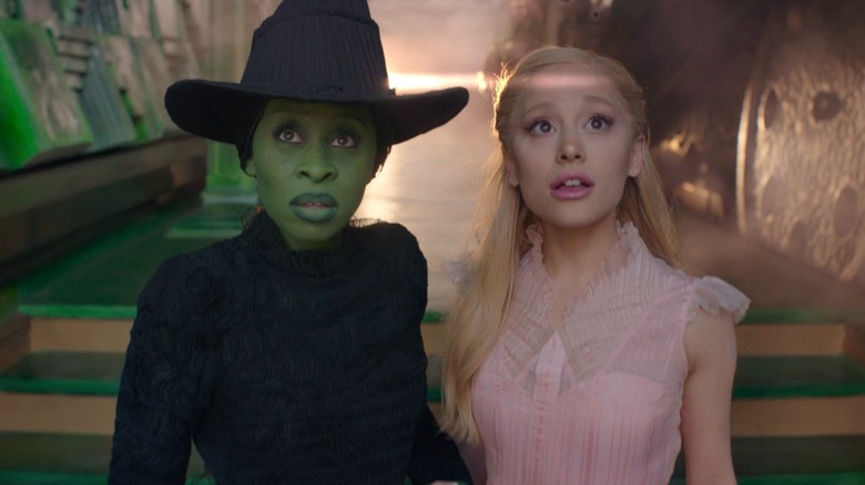 Elphaba and Glinda stand in Oz's palace in "Wicked" (2024)