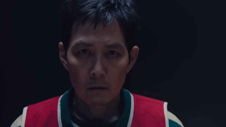 Gi-hun wears a red vest in the dark on "Squid Game" (2021-2025)