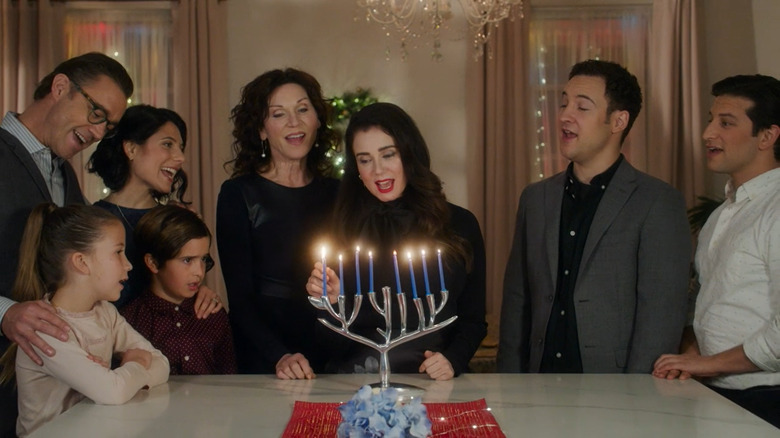 family lighting menorah