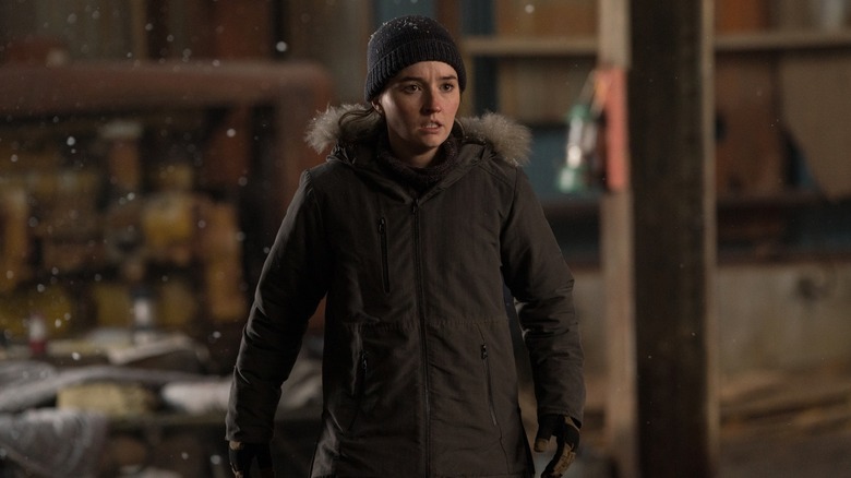 Abby outside in a coat and hat looking horrified in The Last of Us