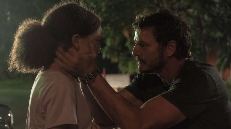 Joel holding Sarah's face in The Last of Us