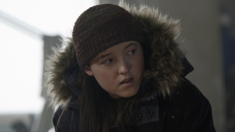 Ellie in a fur coat and hat looking to the side in The Last of Us Season 2 (2025)
