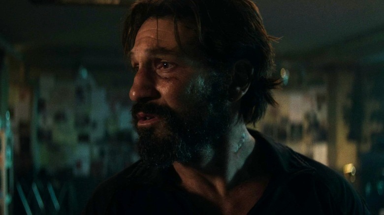 A bearded Punisher in a dark room