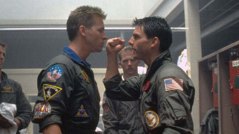 Iceman and Maverick face off in a locker room in Top Gun (1986)